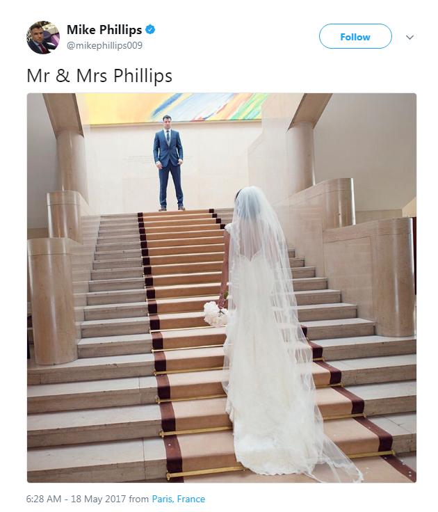 Mike Phillips on the top of the stairs, his wife in her wedding dress at the bottom